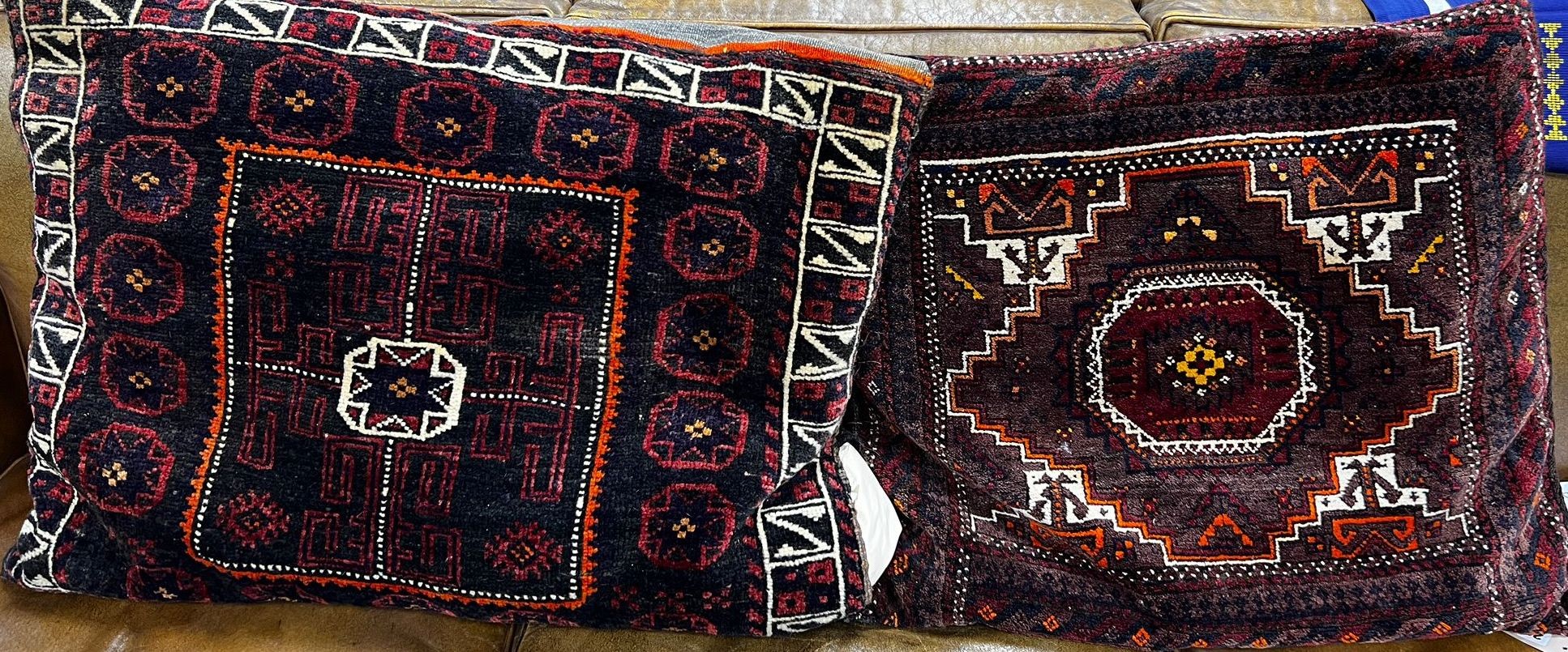 Two cushions made from saddle bags larger 80cm x 60cm and a blue and gold embroidered table runner